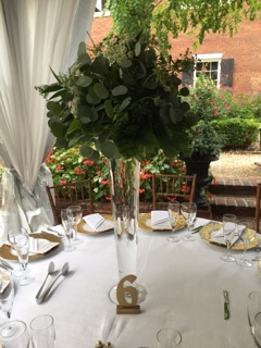 $133 - tall reception centerpiece of greens
